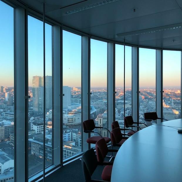 board room with glass windows and city skyline in the background