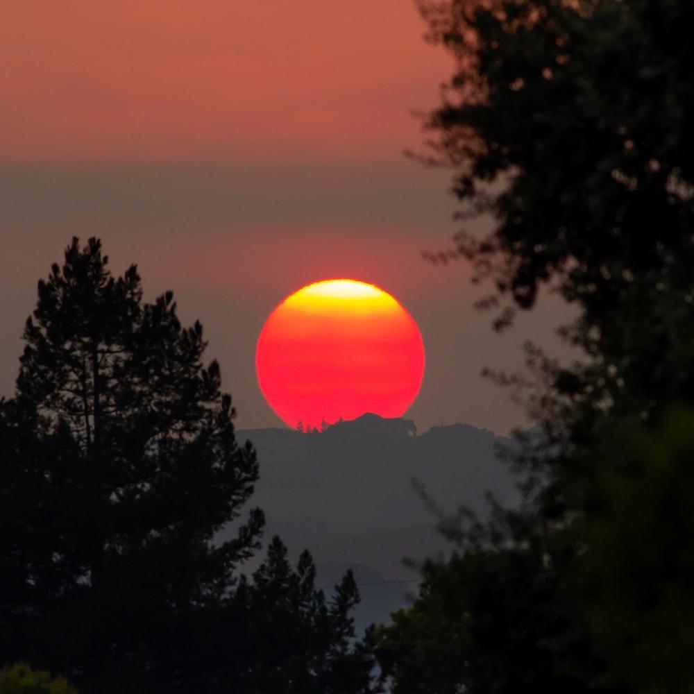 california wildfires glowing sunset climate change ipcc report