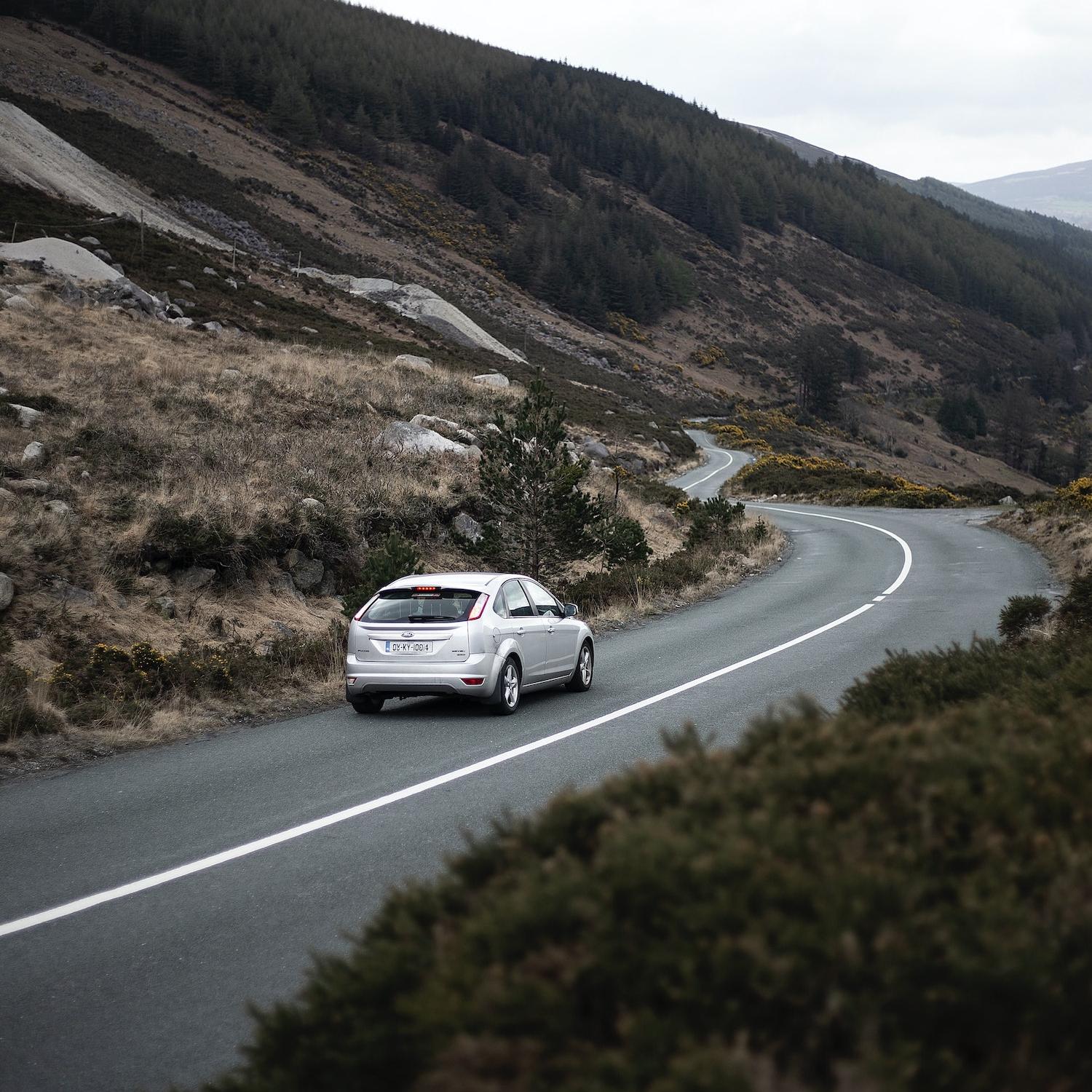 car driving down road