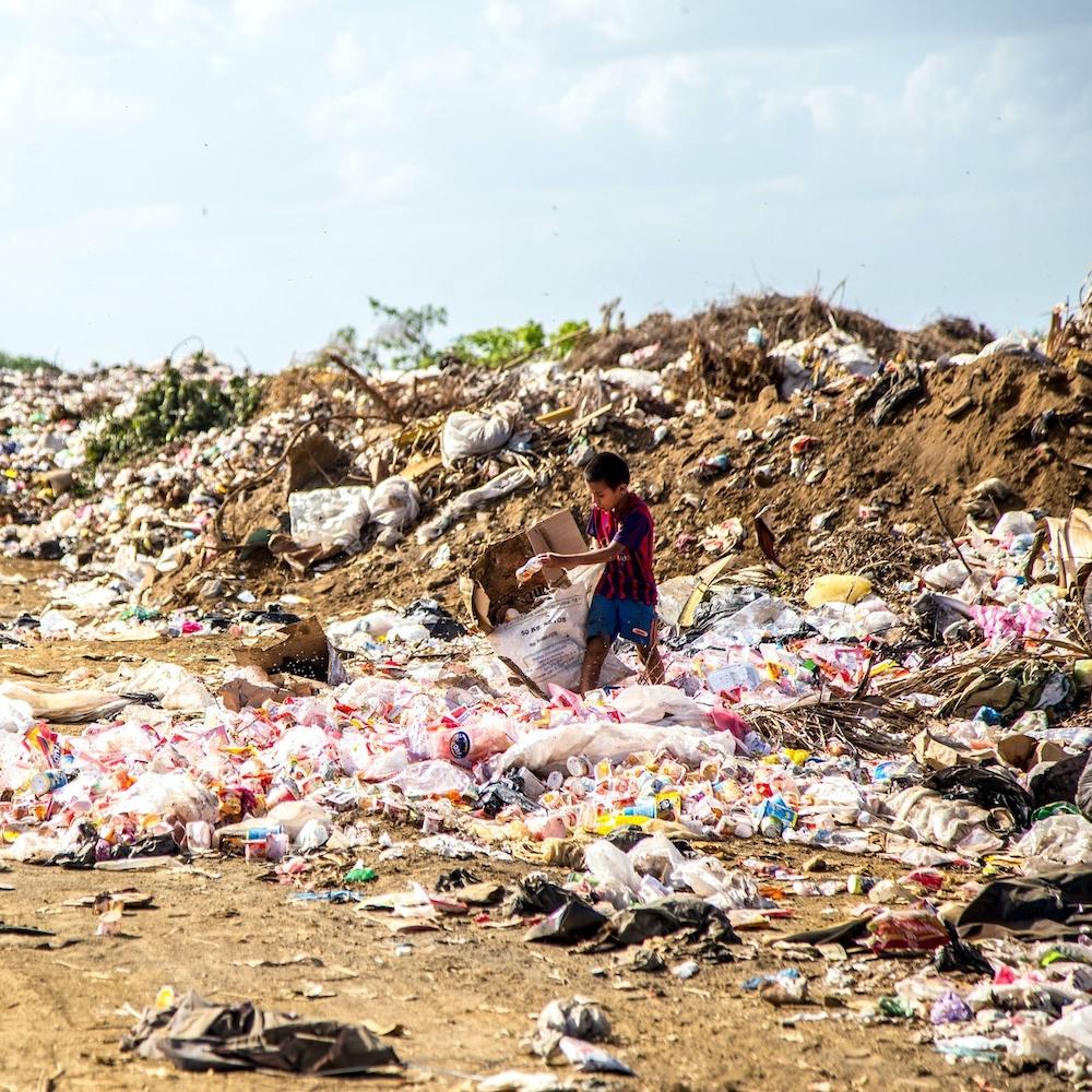 child in a plastic waste dump in nicaragua - Global Plastics Treaty negotiations underway