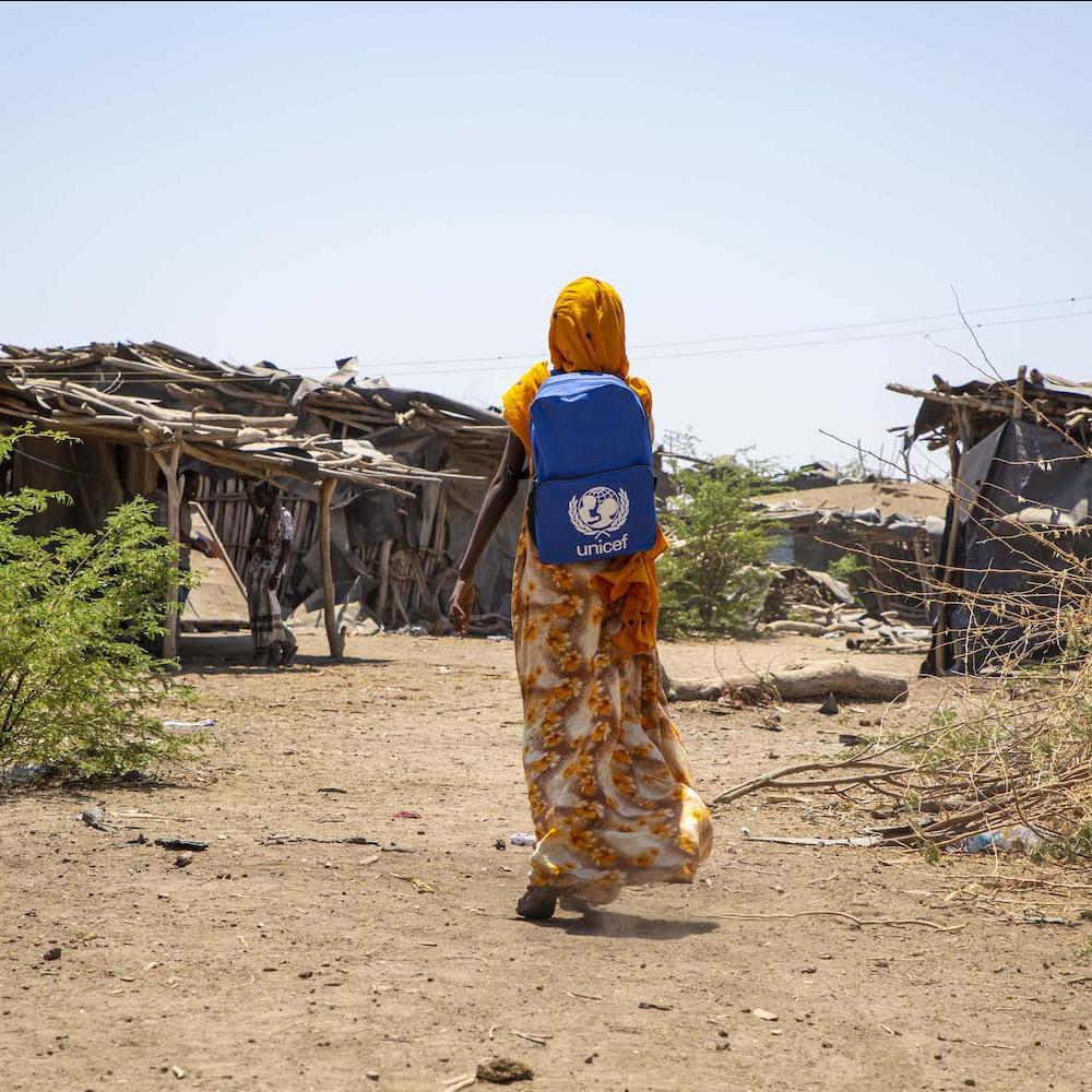 climate change refugee miriam who was displaced by floods in northern ethiopia walks to school with unicef backpack
