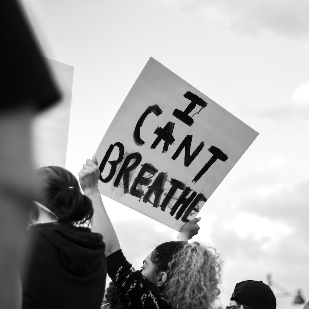 A protester holds a sign that reads "I can't breathe." 