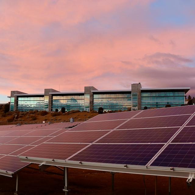 Solar panels in front of a building — climate reporting