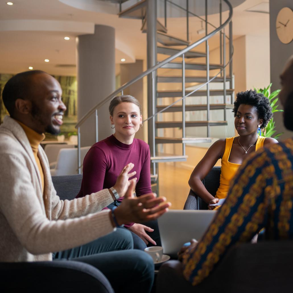 diverse coworkers in a meeting - DEI in the workplace