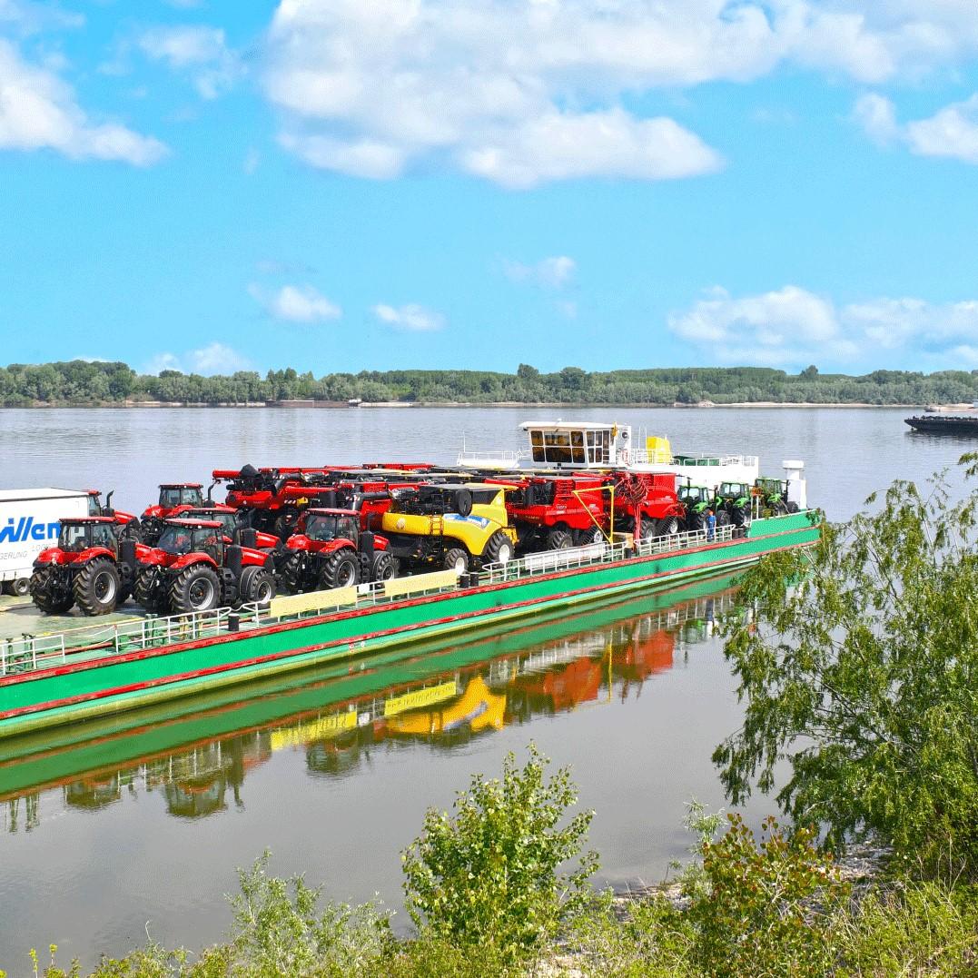 heavy logistics - shipping combine harvesters by barge