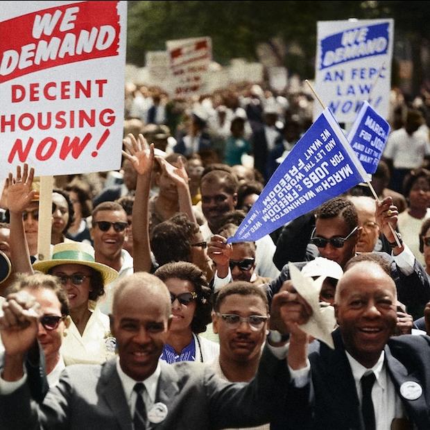 demonstrators attend the 1963 March on Washington - one sign reads 'we demand decent housing now' 