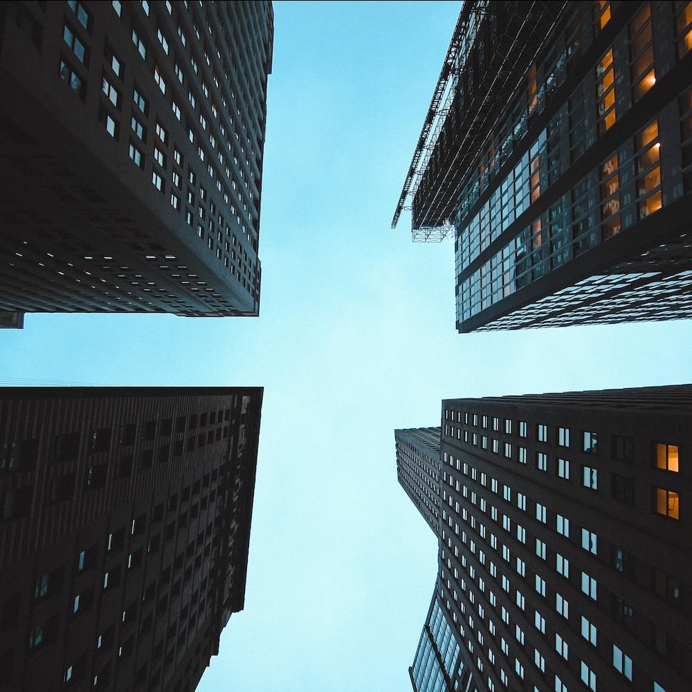 looking up at high rises in the city - ESG matters even during economic downturns