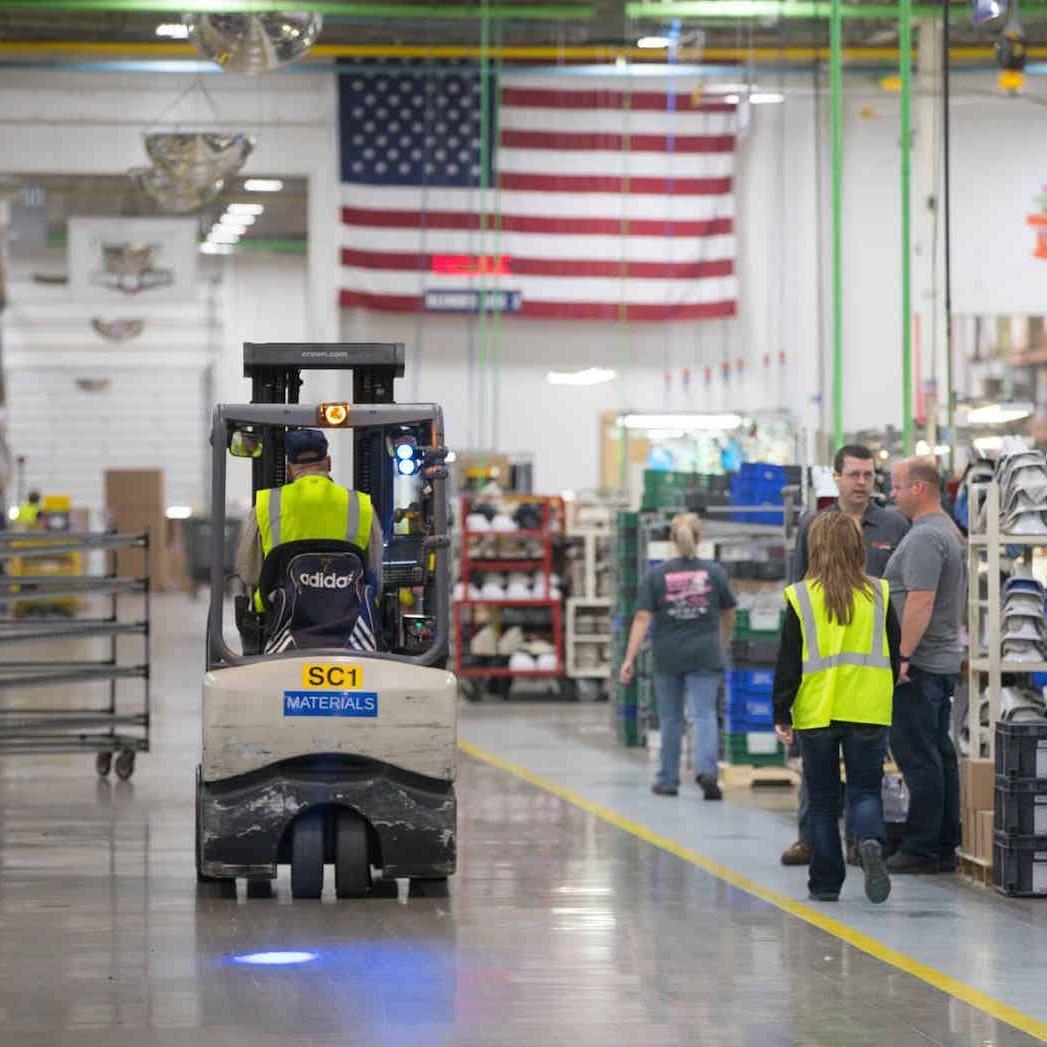 man drives forklift in warehouse - second chance hiring