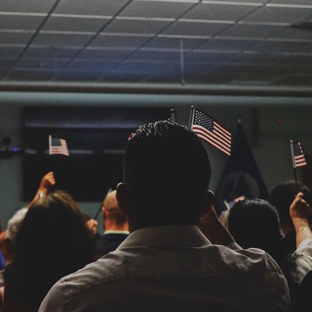 people holding american flags - immigration