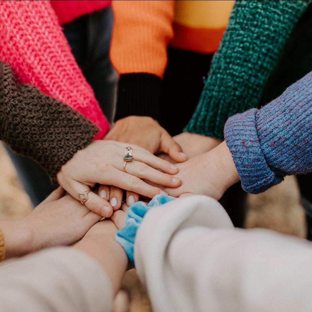 people putting their hands together