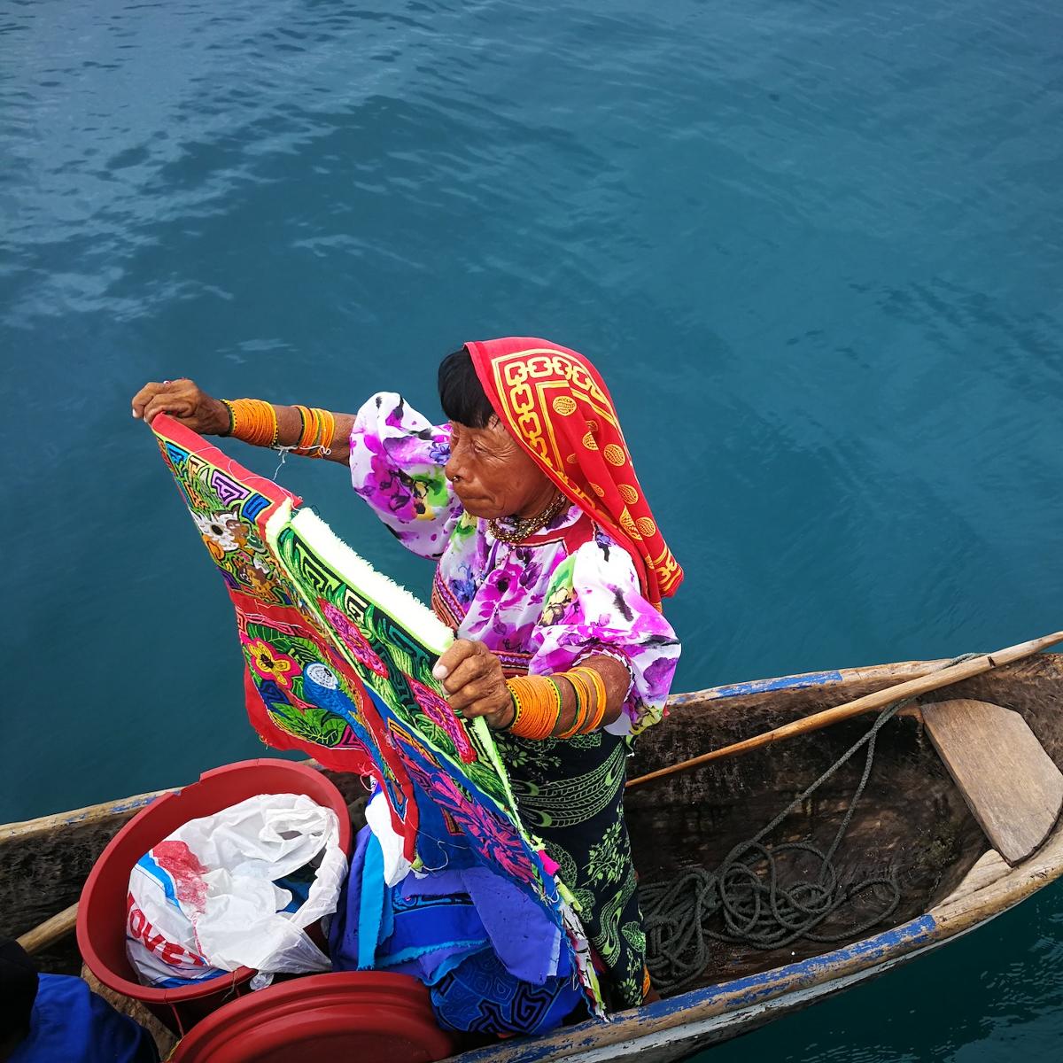 A Guna Yala woman in a canoe displaying her wares.