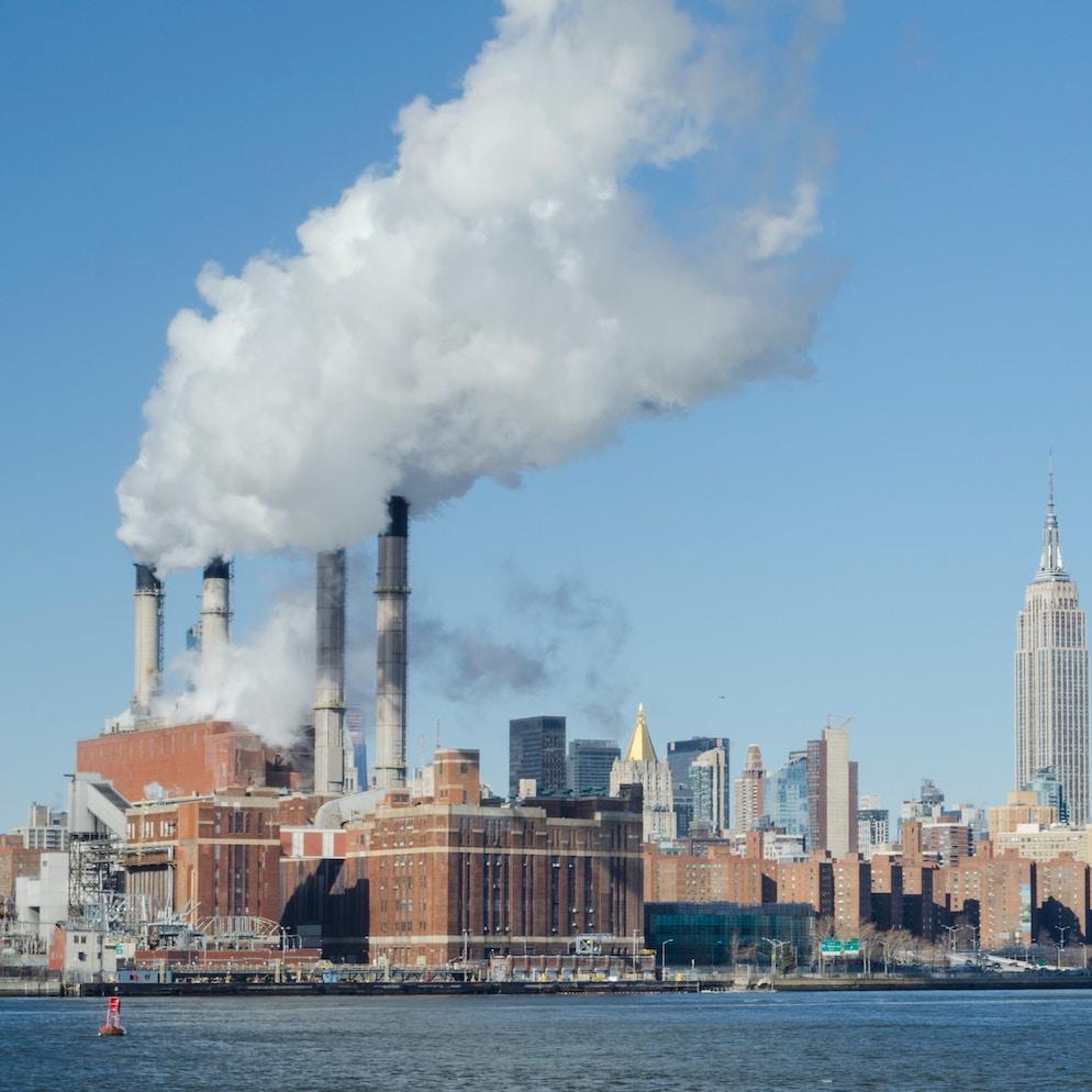 pollution from power plant against new york city skyline - air pollution - climate change - SEC climate disclosure rule