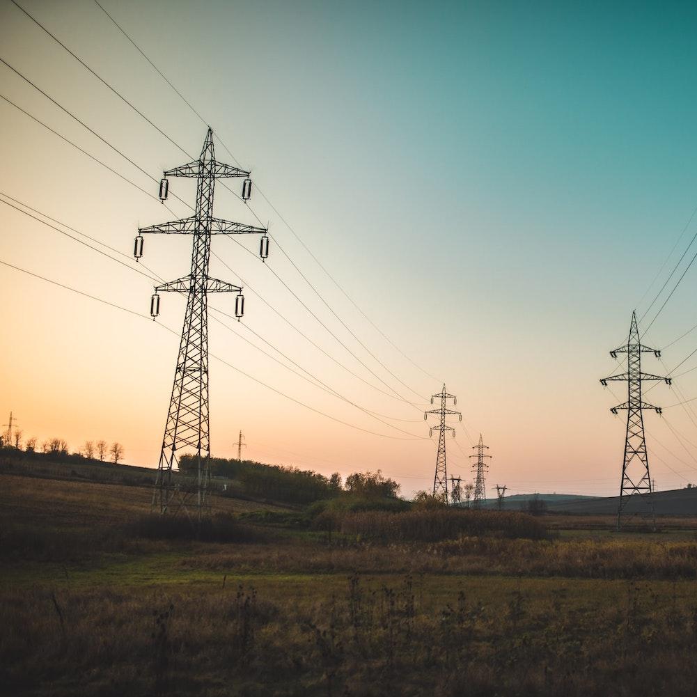 power lines at sunset - decarbonizing the energy grid to fight climate change