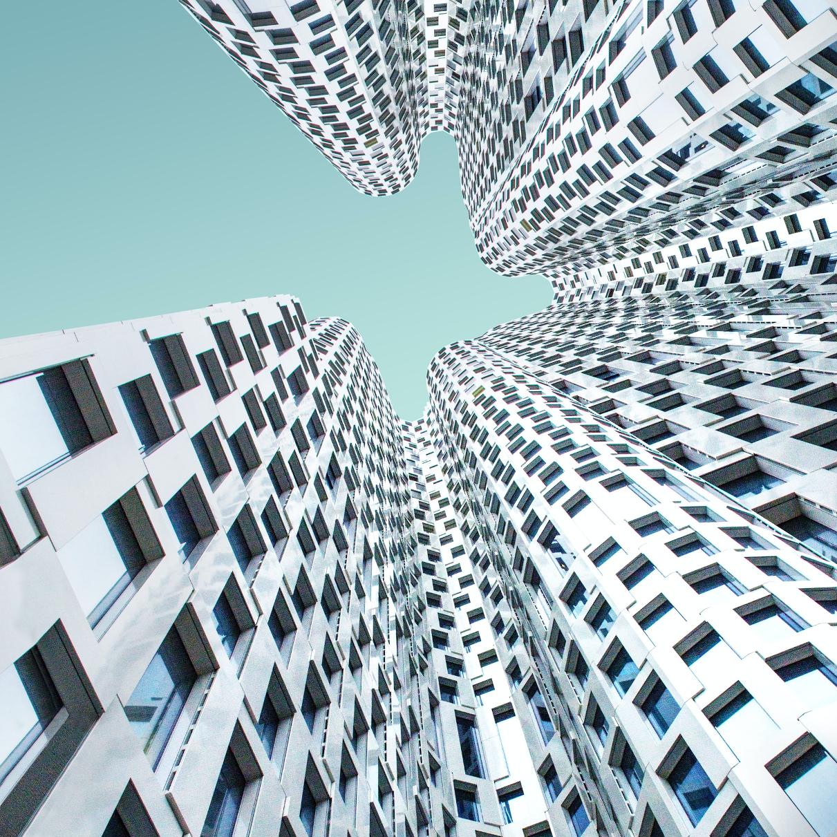 A photo looking up at skyscrapers.
