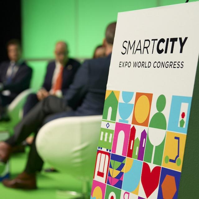 A "Smart City Expo World Congress" sign on stage at one of the event sessions.