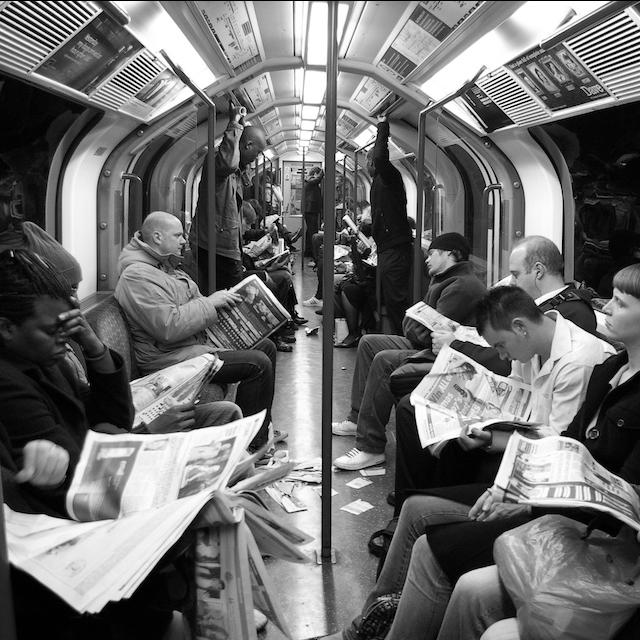 People reading newspapers on a subway — user needs model