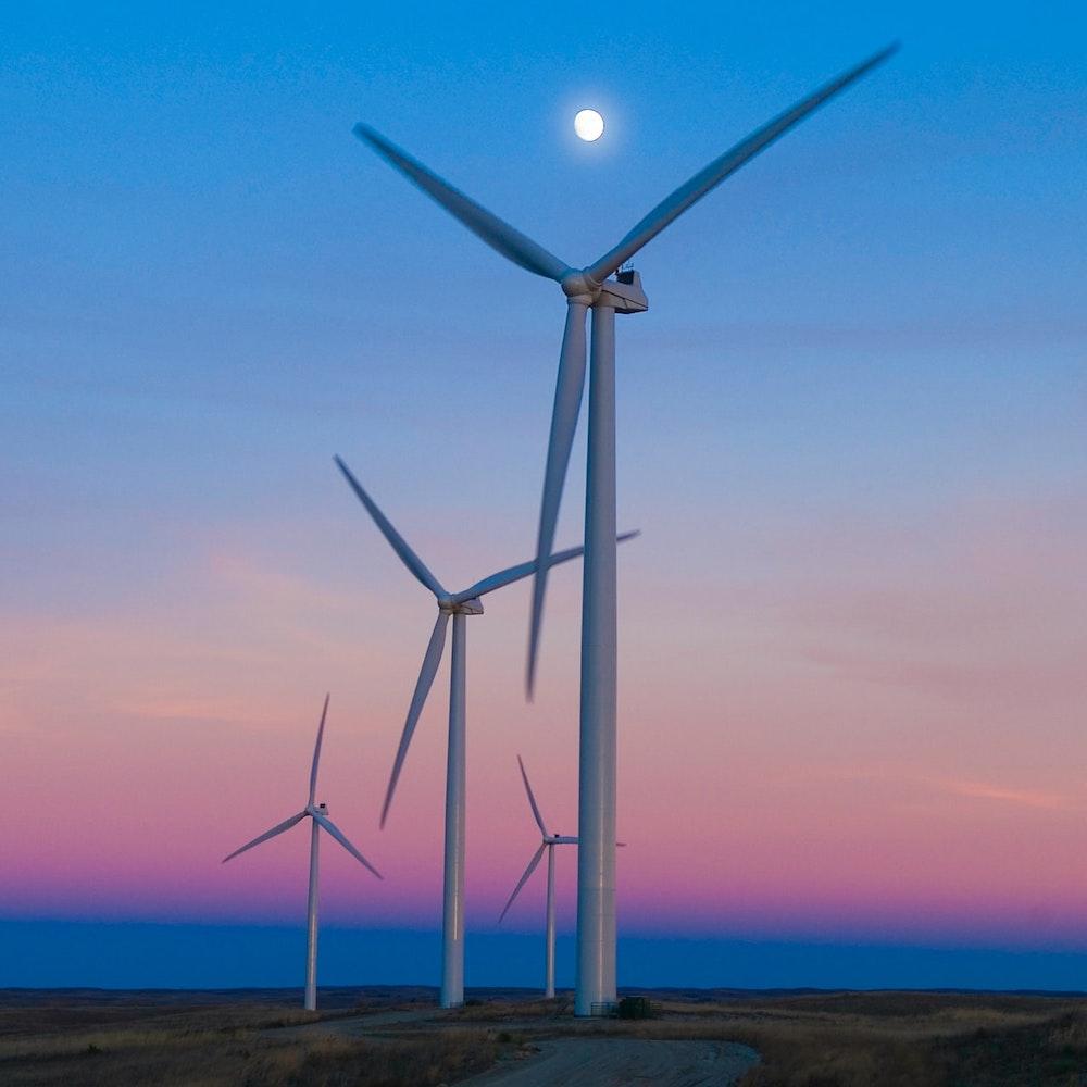 wind farm in nebraska at sunset - clean power