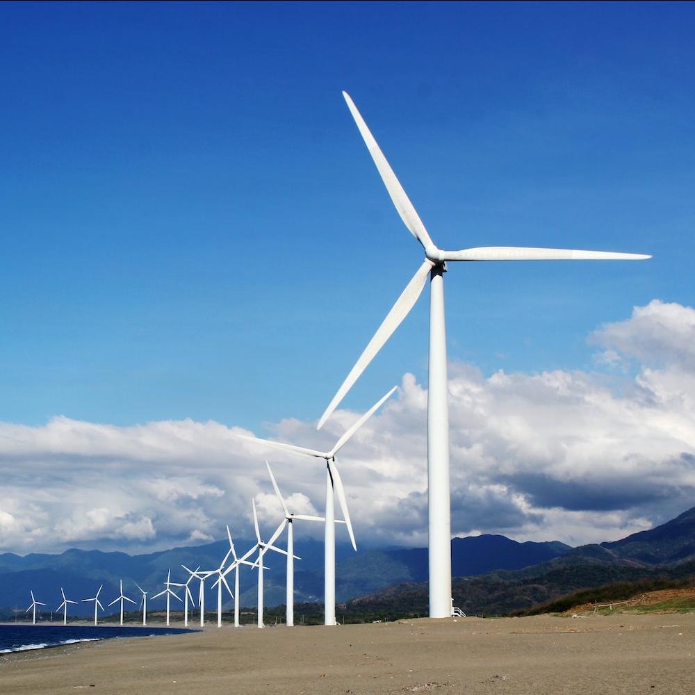 wind farm in the country against blue sky with clouds - renewable energy