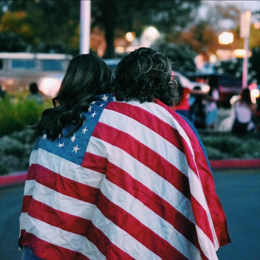 women wrapped in american flag