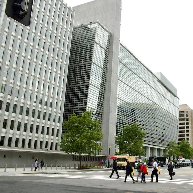 People walking across the street toward The World Bank Group headquarters in Washington D.C. — Approach to Responsible Exit