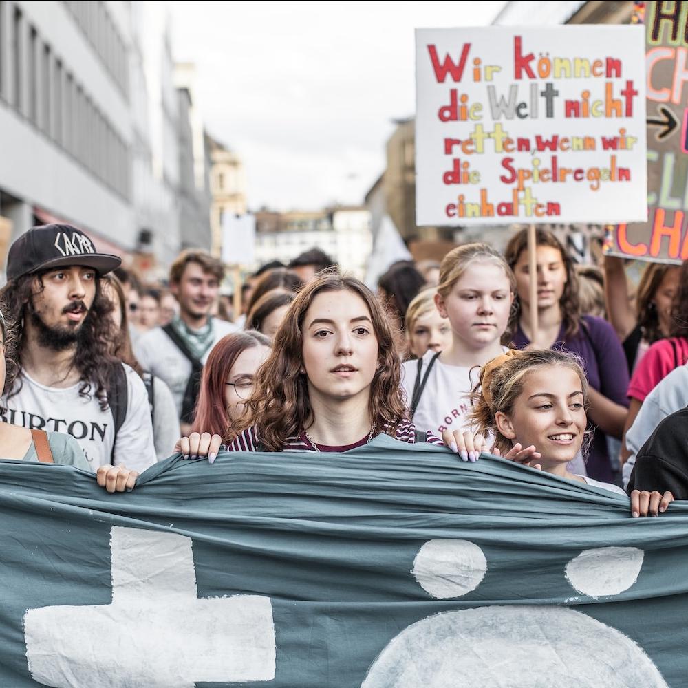 young people at a fridays for future march in support of climate action - how everyday people can counter anti-esg narratives