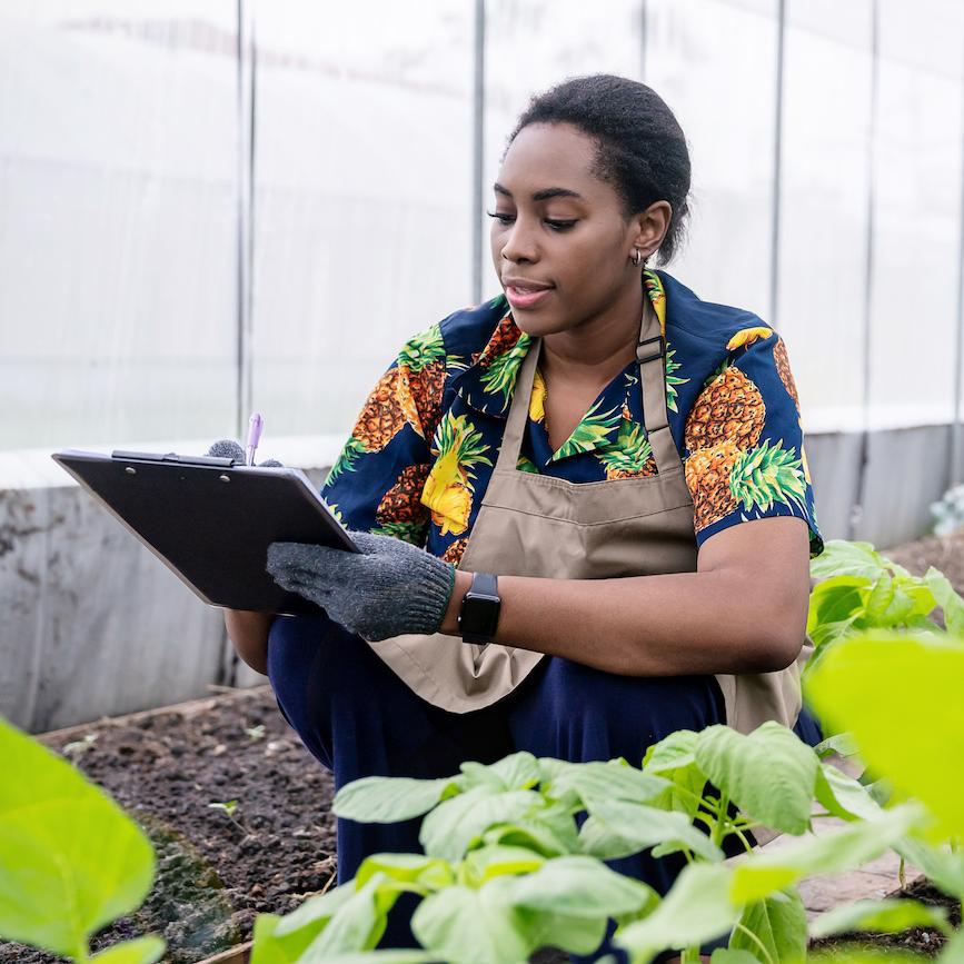 young woman using data for farming - justice for black farmers
